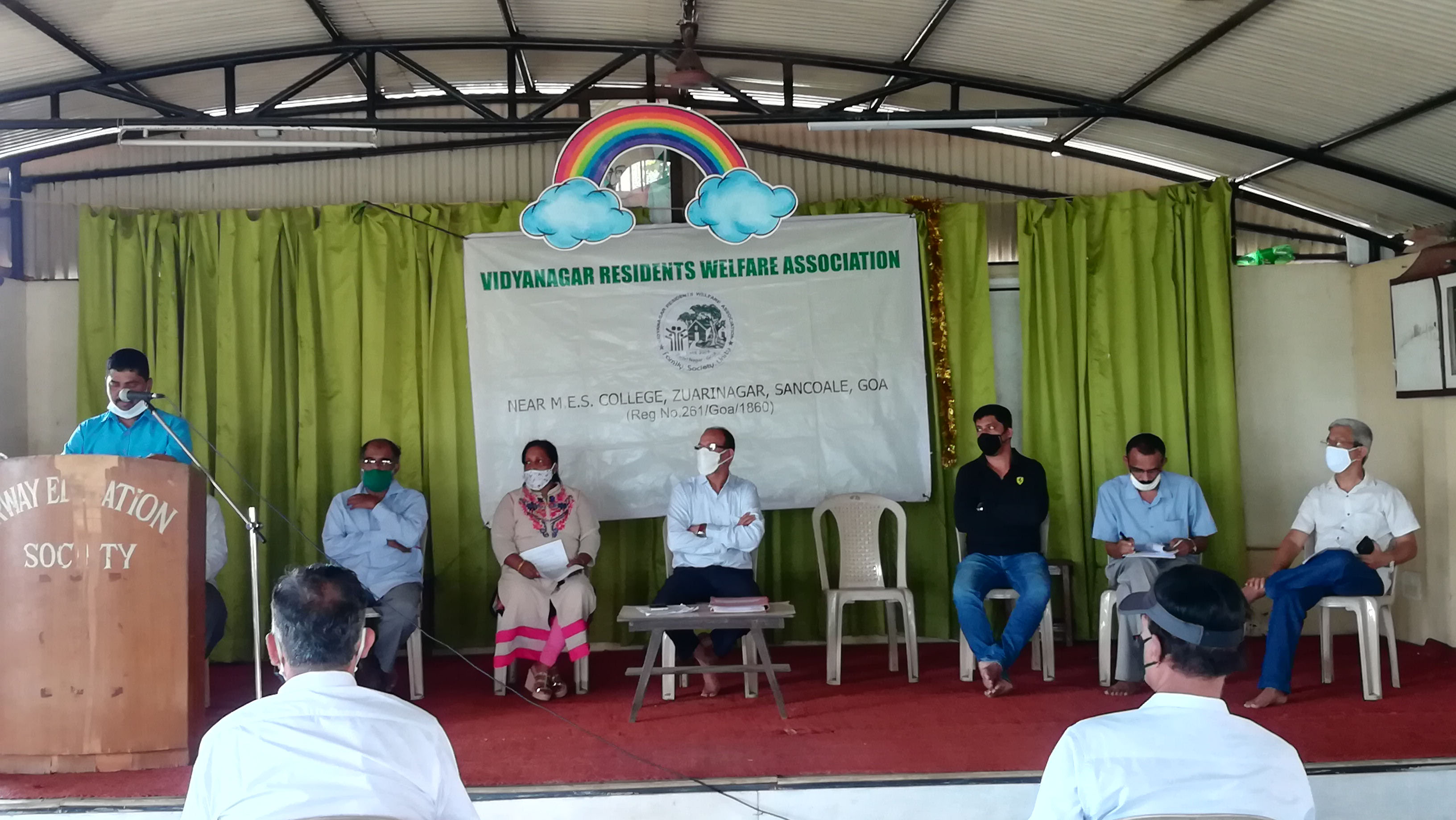 Association Secretary Shri Ganesh Lamani presenting the activity report during the annual General Body Meeting of Vidyanagar Residents Welfare Association held at Airway Public School on 20-Sep-2020.

On the stage from left: Mr. Rafik Shaikh Issak (Co-opted member), Mrs. Luiza Correia (Executive member), Shri Santosh Desai (President), Shri Sagar Toraskar (Joint Secretary), Shri Shantaram Desai (Treasurer) and Shri Balaram Gunjiker (Co-opted member).