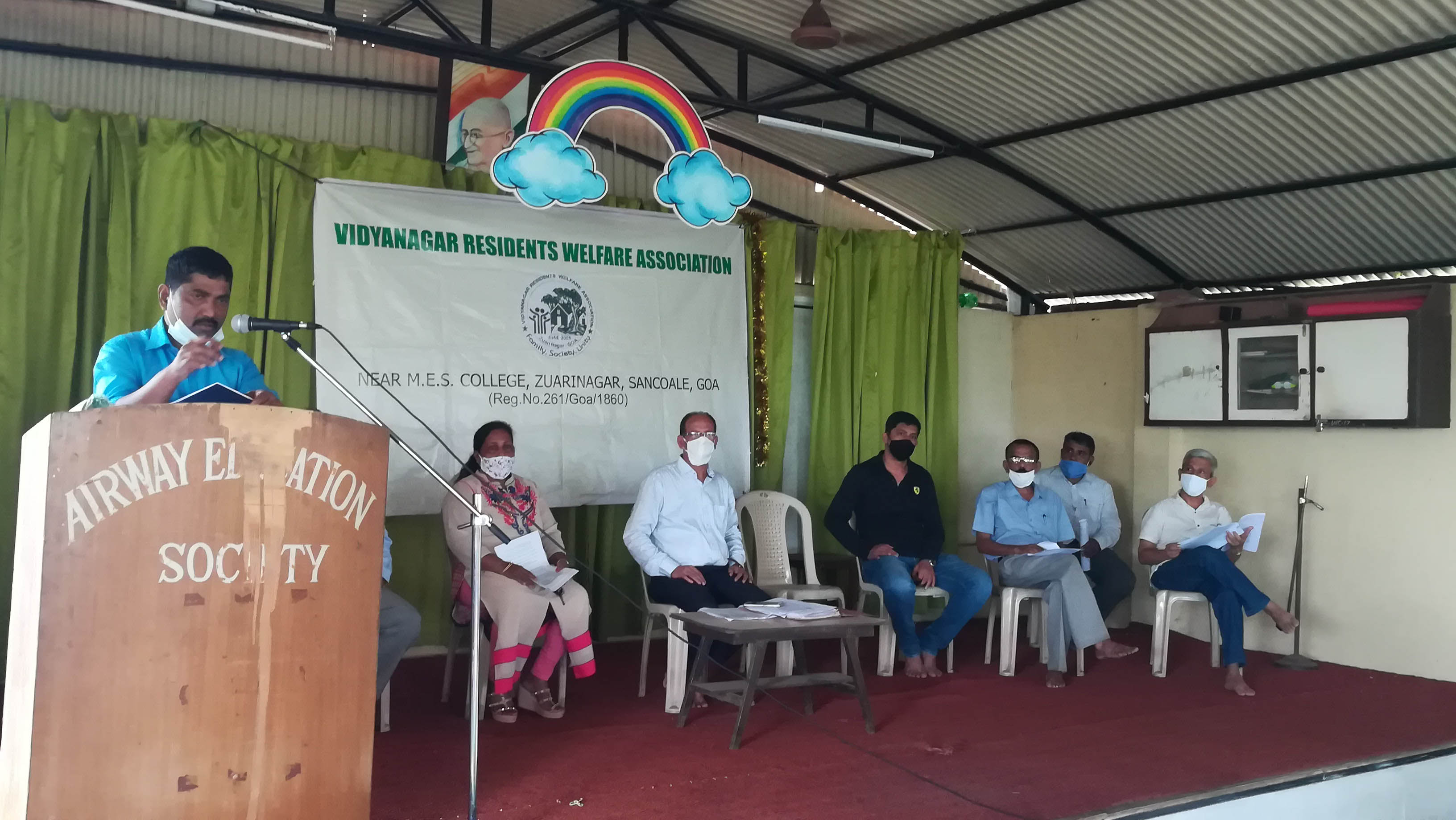 Association Secretary Shri Ganesh Lamani presenting the activity report during the annual General Body Meeting of Vidyanagar Residents Welfare Association held at Airway Public School on 20-Sep-2020.

On the stage from left: Mrs. Luiza Correia (Executive member), Shri Santosh Desai (President), Shri Sagar Toraskar (Joint Secretary), Shri Shantaram Desai (Treasurer), Shri Monish Meti (Co-opted member) and Shri Balaram Gunjiker (Co-opted member).