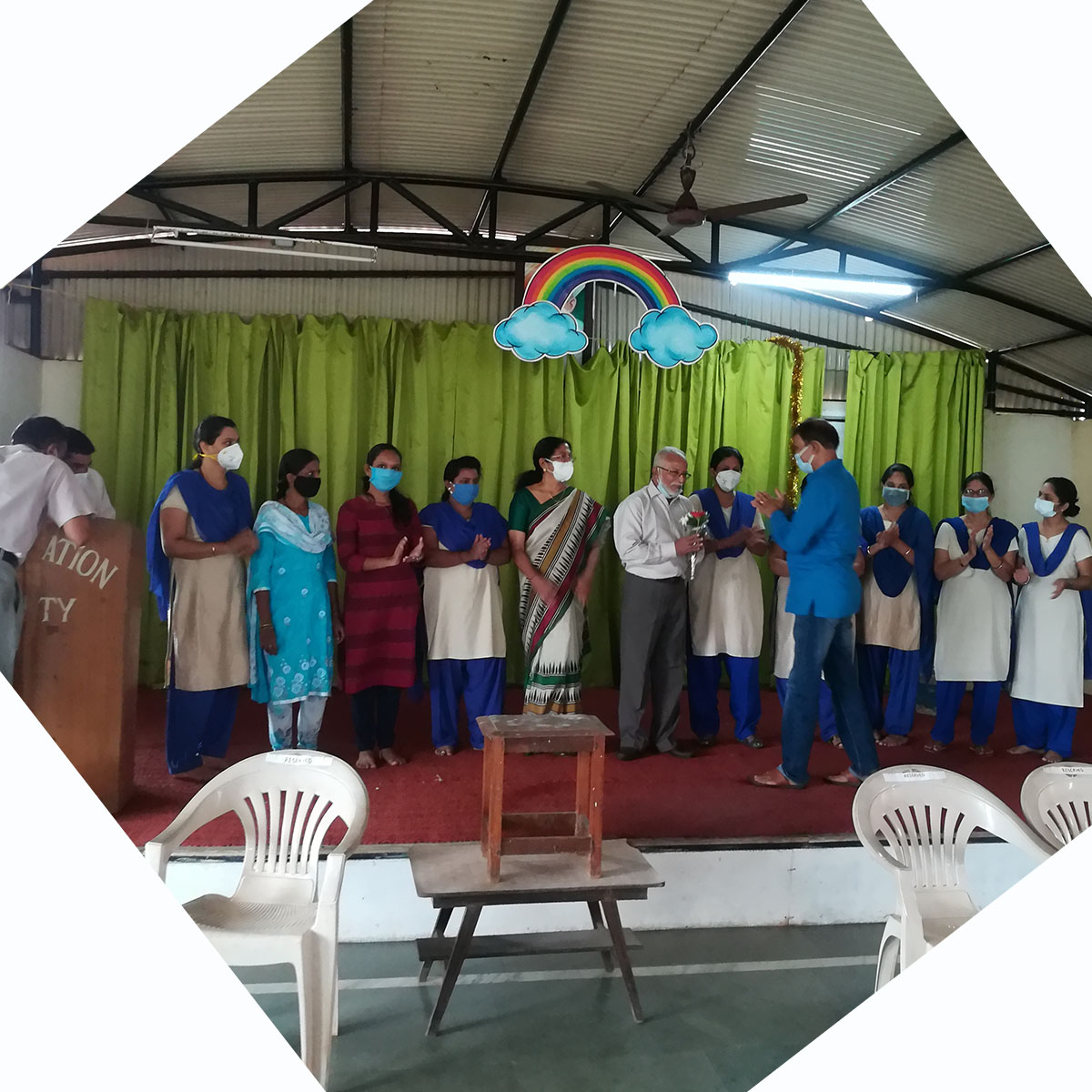 Shri Avinash Tulaskar (in blue) felicitating the principal Mr. Cherian Kurvilla on his School securing 100% results in SSC exams.