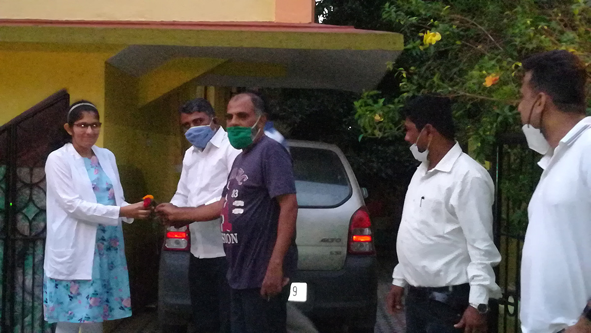 Flower bring presented to Rubiya Shaikh by Association members as a token of appreciation on her achievement.