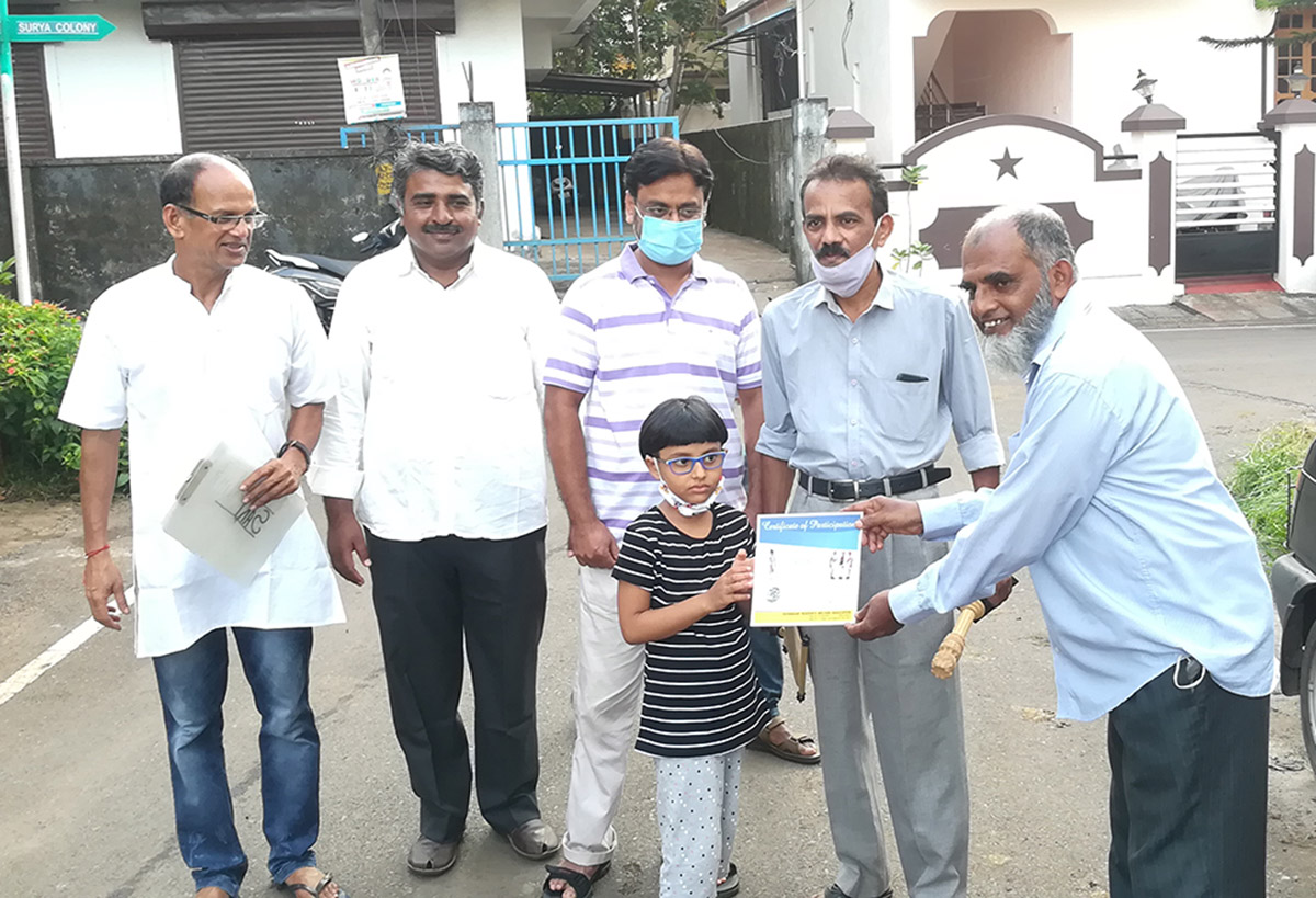 Award of participation certificate to miss Naba Hassan for participating in the Fancy dress competition held on 15-Aug-2021. <a href=https://youtu.be/rV-3WzWU2oc target=_blank class=blue>Competition Video</a><br><br>

Seen in the photo (from left): Association President Shri Santosh Desai, Shri Monesh Meti, Shri Rafique Shaikh Isaac awarding certificate to Naba Hassan, Shri S.M. Hassan and Shri Shantaram Desai (background).