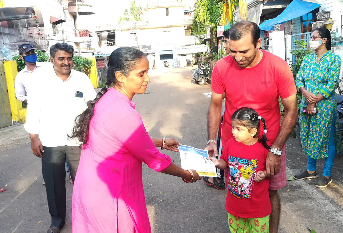 Award of participation certificate to miss Ahana M Pai Vaidya for participating in the Fancy dress competition held on 15-Aug-2021. <a href=https://youtu.be/7asIt0xWKfw target=_blank class=blue>Competition Video</a><br><br>
Seen in the photo (from left): Smt Yadvesh Ghonge presenting certificate to Ahana M Pai Vaidya, Shri Wilfred Fernandes and Monesh Meti (background), Shri Mayurish Vaidya and Smt Shantaram Desai (background).
