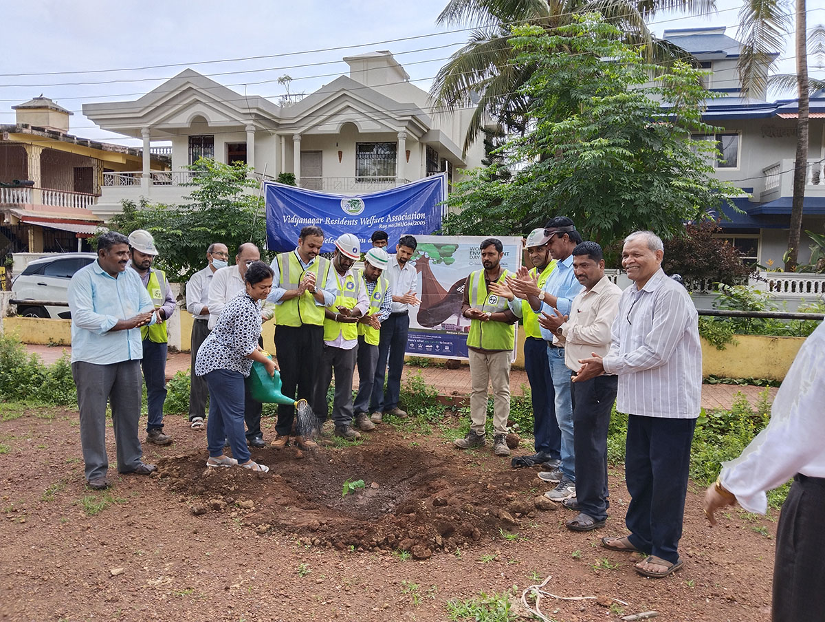 Seen here is Mrs. Varsha Naik watering the sapling. Also in the photo is President of Vidyanagar Residents Welfare Association; Shri Monesh Meti, Mr.Jayant Prabhakar Gosavi, Project Manager,  L&T Ltd., Adora De Goa Project (partially visible), members of L&T, Mr. Wilfred Fernandes (left), Association secretary Shri Ganesh Lamani and Shri Rajaram Patil.