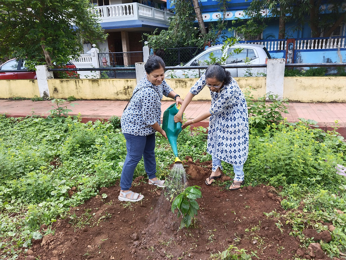 Seen here are Mrs Varsha Naik and Mrs Tejal Nayak watering the sapling.