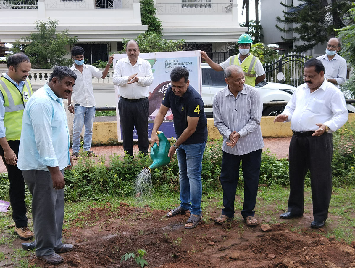 Seen here is Shri Surendra Naik watering the sapling. Also in the photo is Vidyanagar Residents Welfare Association; President Shri Monish Meti (left), Project Manager,  L&T Ltd., Adora De Goa Project (white shirt in the background), Shri Rajaram Patil and Shri L.T. Naik along with other members of L&T.