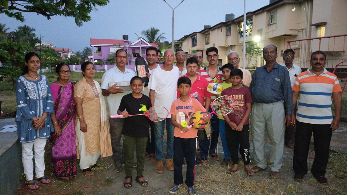 Group photo after distribution of sports kits to children of Bharatnagar and LED lighting for the badminton court.